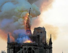 - AFP PICTURES OF THE YEAR 2019 - The steeple and spire of the landmark Notre-Dame Cathedral collapses as the cathedral is engulfed in flames in central Paris on April 15, 2019. A huge fire swept through the roof of the famed Notre-Dame Cathedral in central Paris on April 15, 2019, sending flames and huge clouds of grey smoke billowing into the sky. The flames and smoke plumed from the spire and roof of the gothic cathedral, visited by millions of people a year. A spokesman for the cathedral told AFP that the wooden structure supporting the roof was being gutted by the blaze. / AFP / Geoffroy VAN DER HASSELT